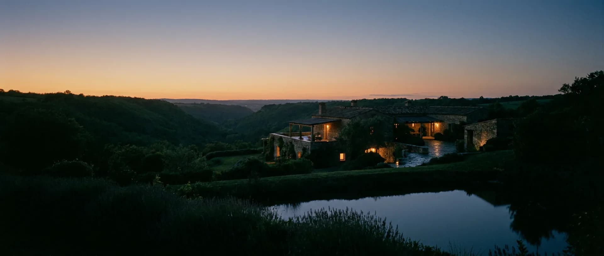 A quiet estate settled into a green valley at twilight